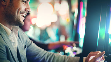 A young man plays a winning slot machine at Argosy Casino Alton.