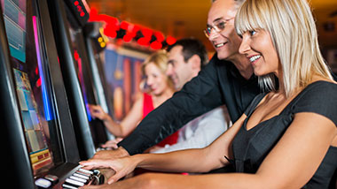 Two older people at a winning machine at Argosy Casino Alton.
